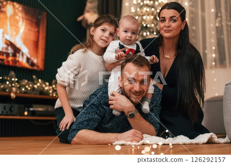 Happy family is sitting together at home. Celebrating New Year 126292157