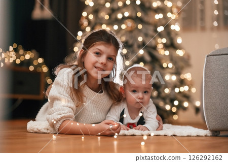 Girl with her little son is at home, celebrating new year Girl with her little son is at home, celebrating new year 126292162