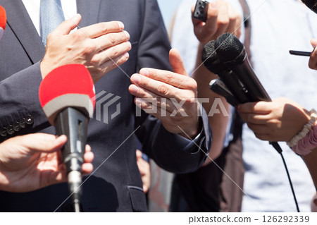 Business person or politician gesturing during press conference Business person or politician gesturing during press conference 126292339