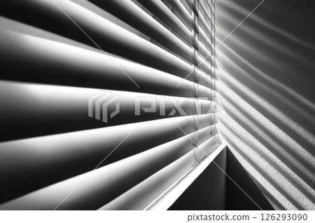 Window blinds casting shadows on textured wall 126293090