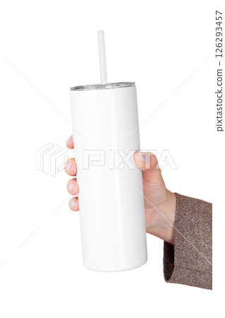 Female Hand Holding 20 oz skinny tumbler for sublimation. Travel Mug Straw Covers Cup with Lid. Isolated background Female Hand Holding 20 oz skinny tumbler for sublimation. Travel Mug Straw Covers Cup with Lid. Isolated background 126293457