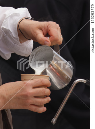 Barista Pouring Steamed Milk Into a Coffee Cup in a Cafe Setting Barista Pouring Steamed Milk Into a Coffee Cup in a Cafe Setting 126293779