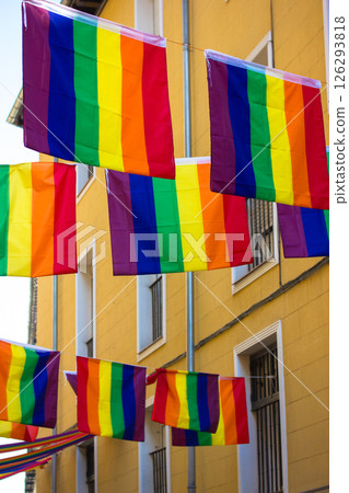 Colorful rainbow flags are strung across a street, decorating city for celebrating the pride month. Diversity of lgbtq community. Love is love concept 126293818