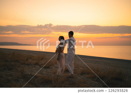 Future Parents Enjoying Peaceful Sunset by the Shore Future Parents Enjoying Peaceful Sunset by the Shore 126293826
