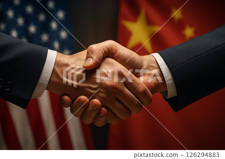 Handshake between businesspeople from China and USA in front of flags, representing trade agreement, diplomacy and international cooperation 126294883