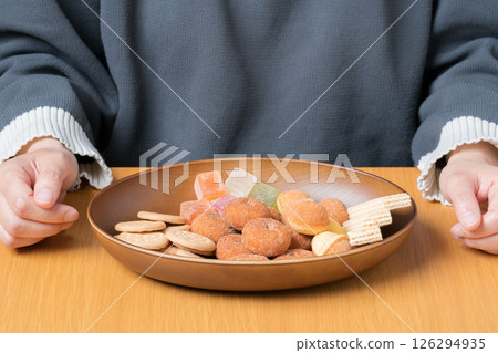 A delicious assortment of sweet treats prepared in front of a woman A delicious assortment of sweet treats prepared in front of a woman 126294935