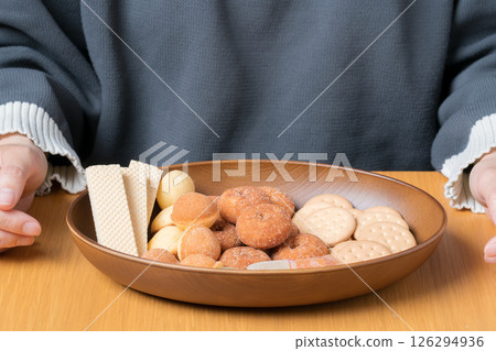 A delicious assortment of sweet treats prepared in front of a woman 126294936