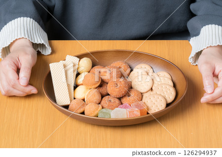 A delicious assortment of sweet treats prepared in front of a woman 126294937