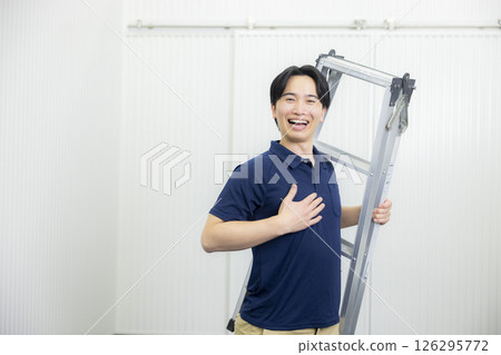 A young man posing with a stepladder A young man posing with a stepladder 126295772