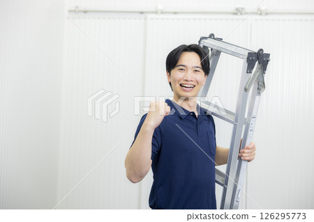 A young man posing with a stepladder 126295773
