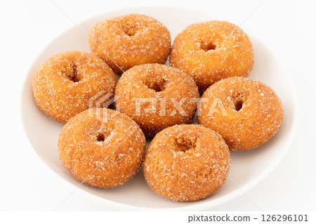 Delicious mini donuts served on a plate on a white background 126296101
