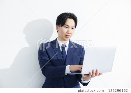 Businessman using a personal computer Businessman using a personal computer 126296162