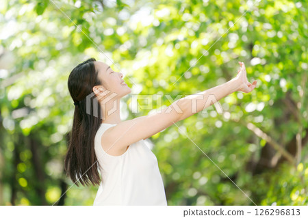 A woman refreshing in the fresh greenery A woman refreshing in the fresh greenery 126296813