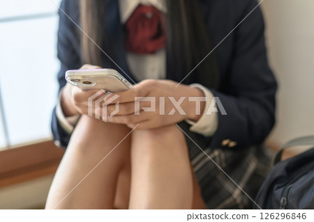 High school girl looking at smartphone in Japanese-style room, contact, career advice, SNS, positive, bright natural color 126296846