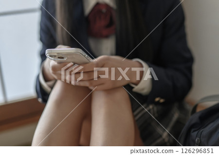 High school girl looking at smartphone in Japanese-style room, bullying, school refusal, SNS trouble High school girl looking at smartphone in Japanese-style room, bullying, school refusal, SNS trouble 126296851