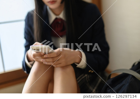 High school girl looking at smartphone in Japanese-style room, contact, career advice, SNS, natural color 126297134