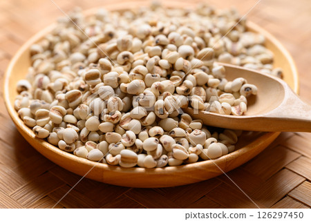 Dried Job's tears or adlay millet seeds in wooden bowl with spoon, Food ingredient 126297450