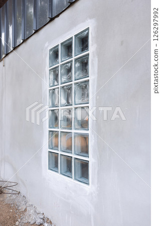 Clear glass block and concrete wall. 126297992