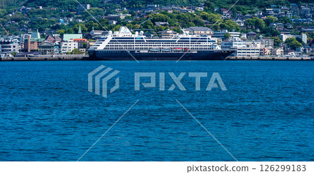 Panorama from the opposite shore of a passenger ship arriving at Nagasaki Port (Azamara Pursuit) [Nagasaki City] 126299183