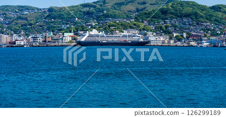 Panorama from the opposite shore of a passenger ship arriving at Nagasaki Port (Azamara Pursuit) [Nagasaki City] 126299189