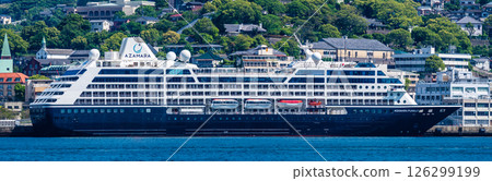 Panorama from the opposite shore of a passenger ship arriving at Nagasaki Port (Azamara Pursuit) [Nagasaki City] 126299199