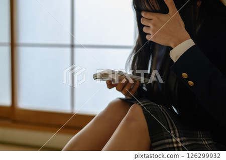 High school girl looking at smartphone in Japanese-style room, bullying, school refusal, SNS trouble, natural color High school girl looking at smartphone in Japanese-style room, bullying, school refusal, SNS trouble, natural color 126299932