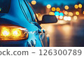 Nighttime urban drive features blurred lights and reflections on a parked car 126300789