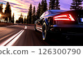 Luxury sports car driving on a winding road surrounded by tall trees at sunset 126300790