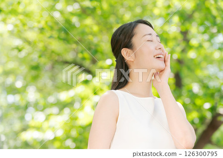 綠樹中微笑的女人的形象 綠樹中微笑的女人的形象 126300795