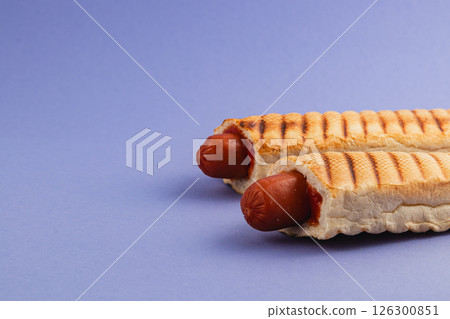 Unique grilled hot dogs served in crispy waffle cones 126300851