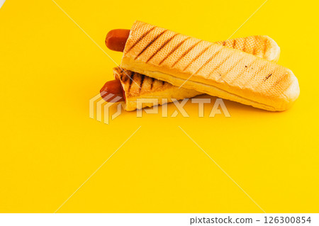 Delicious hot dogs served in crispy waffle cones on yellow 126300854