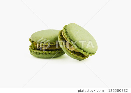 Green macarons with nut filling on a white background 126300882