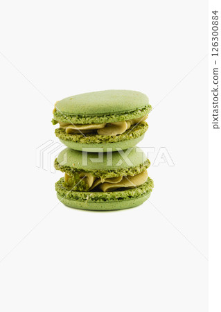 Green macarons stacked on a white background 126300884