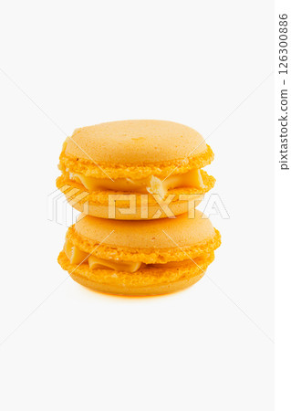 Bright yellow macarons stacked on top of each other 126300886