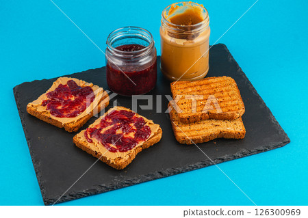 Slices of toasted bread with peanut butter and jam 126300969
