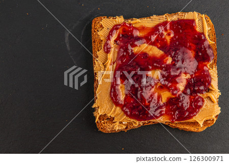 Delicious peanut butter and jelly spread on toasted bread slice Delicious peanut butter and jelly spread on toasted bread slice 126300971