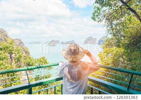 Woman tourist traveling in Krabi, Thailand. happy traveller enjoy and sightseeing view at koh Hong island viewpoint. summer trip, destination, Southeast Asia Travel, vacation and holiday concept Woman tourist traveling in Krabi, Thailand. happy traveller enjoy and sightseeing view at koh Hong island viewpoint. summer trip, destination, Southeast Asia Travel, vacation and holiday concept 126301363