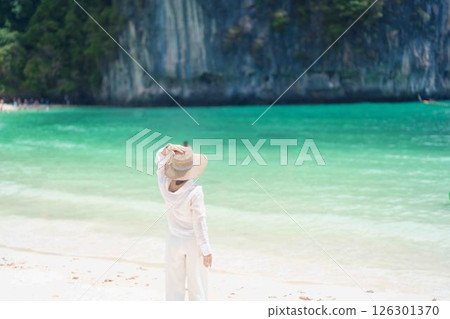 Woman tourist traveling and sightseeing in Krabi, Thailand. happy traveller enjoy on beach at koh Hong island. summer trip, destination, Southeast Asia Travel, vacation and holiday concept 126301370
