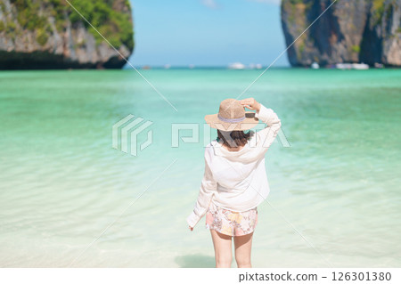 Woman tourist traveling and sightseeing in Krabi, Thailand, happy traveller enjoy at Maya Bay beach on Phi Phi island, Popular paradise island, destination, Southeast Asia Travel, vacation and holiday Woman tourist traveling and sightseeing in Krabi, Thailand, happy traveller enjoy at Maya Bay beach on Phi Phi island, Popular paradise island, destination, Southeast Asia Travel, vacation and holiday 126301380