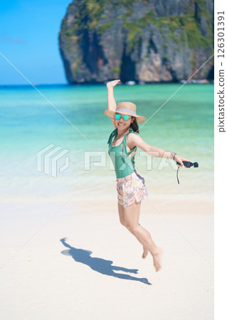 Woman tourist traveling and sightseeing in Krabi, Thailand, happy traveller enjoy at Maya Bay beach on Phi Phi island, Popular paradise island, destination, Southeast Asia Travel, vacation and holiday 126301391
