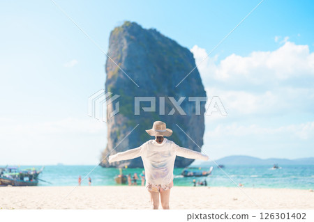 Woman tourist traveling and sightseeing in Krabi, Thailand. happy traveller enjoy on beach at Koh Poda island. summer trip, destination, Southeast Asia Travel, vacation and holiday concept Woman tourist traveling and sightseeing in Krabi, Thailand. happy traveller enjoy on beach at Koh Poda island. summer trip, destination, Southeast Asia Travel, vacation and holiday concept 126301402