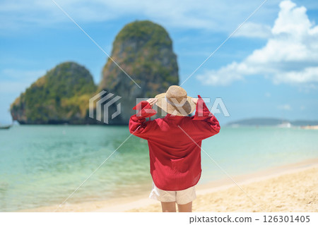 Woman tourist travel and sightseeing in Krabi, Thailand. happy traveller enjoy on beach at Phra nang Cave Beach near Railay Beach. summer trip, destination, Southeast Asia Travel and vacation concept Woman tourist travel and sightseeing in Krabi, Thailand. happy traveller enjoy on beach at Phra nang Cave Beach near Railay Beach. summer trip, destination, Southeast Asia Travel and vacation concept 126301405