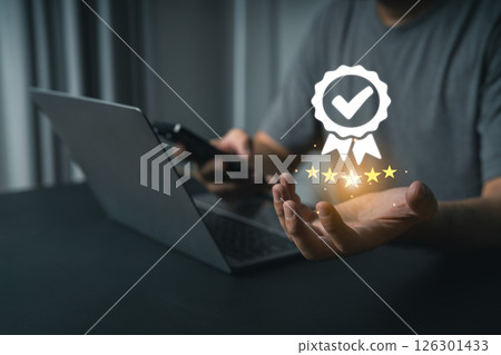 Close-up businessman hand Using Laptop and Smartphone Symbolizing Digital Achievement with Stars, Checkmark, and Award Icon Representing Success and Quality Assurance Close-up businessman hand Using Laptop and Smartphone Symbolizing Digital Achievement with Stars, Checkmark, and Award Icon Representing Success and Quality Assurance 126301433
