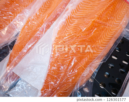 Salmon fillet in a vacuum package plastic bag. 126301577