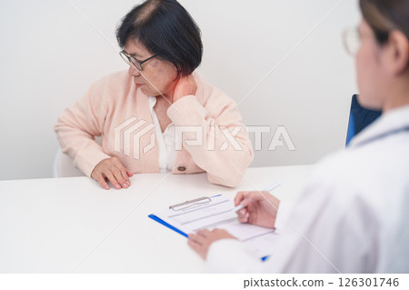 Elderly Woman having Shoulder and Neck and consulting doctor in hospital. Muscle painful due to Myofascial pain syndrome and Fibromyalgia, rheumatism, Scapular pain, Cervical Spine. ergonomic concept Elderly Woman having Shoulder and Neck and consulting doctor in hospital. Muscle painful due to Myofascial pain syndrome and Fibromyalgia, rheumatism, Scapular pain, Cervical Spine. ergonomic concept 126301746