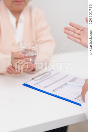 Senior woman with Tremor hand during taking glass of water in hospital. Parkinson disease April awareness month, Carpal Tunnel Syndrome, rheumatoid and brain injury and Neurological disorder concept Senior woman with Tremor hand during taking glass of water in hospital. Parkinson disease April awareness month, Carpal Tunnel Syndrome, rheumatoid and brain injury and Neurological disorder concept 126301756