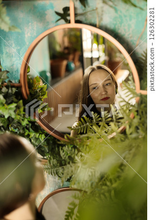 Reflective Moment in Greenery A Woman in a Beautifully Decorated Living Space of Nature 126302281