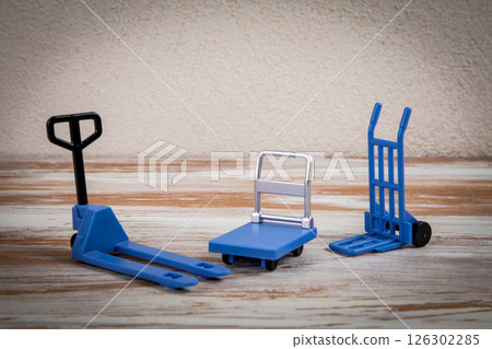 Miniature warehouse equipment on a wooden texture background 126302285