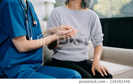 female hands touching senior male hand Helping hands take care of the elderly concept 126302348