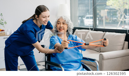 Physiotherapist helping elderly man patient stretching arm during exercise correct with dumbbell in hand during training hand with patient Back problems 126302395